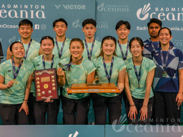 Winners of the VICTOR Oceania Mixed Team Badminton title holding trophy.