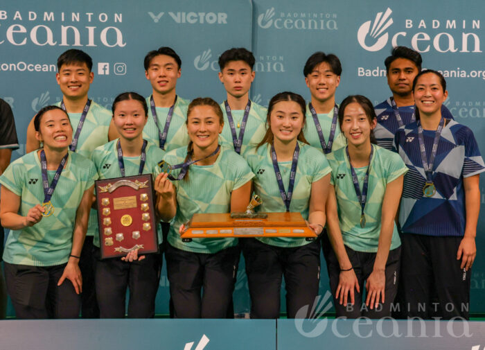 Winners of the VICTOR Oceania Mixed Team Badminton title holding trophy.
