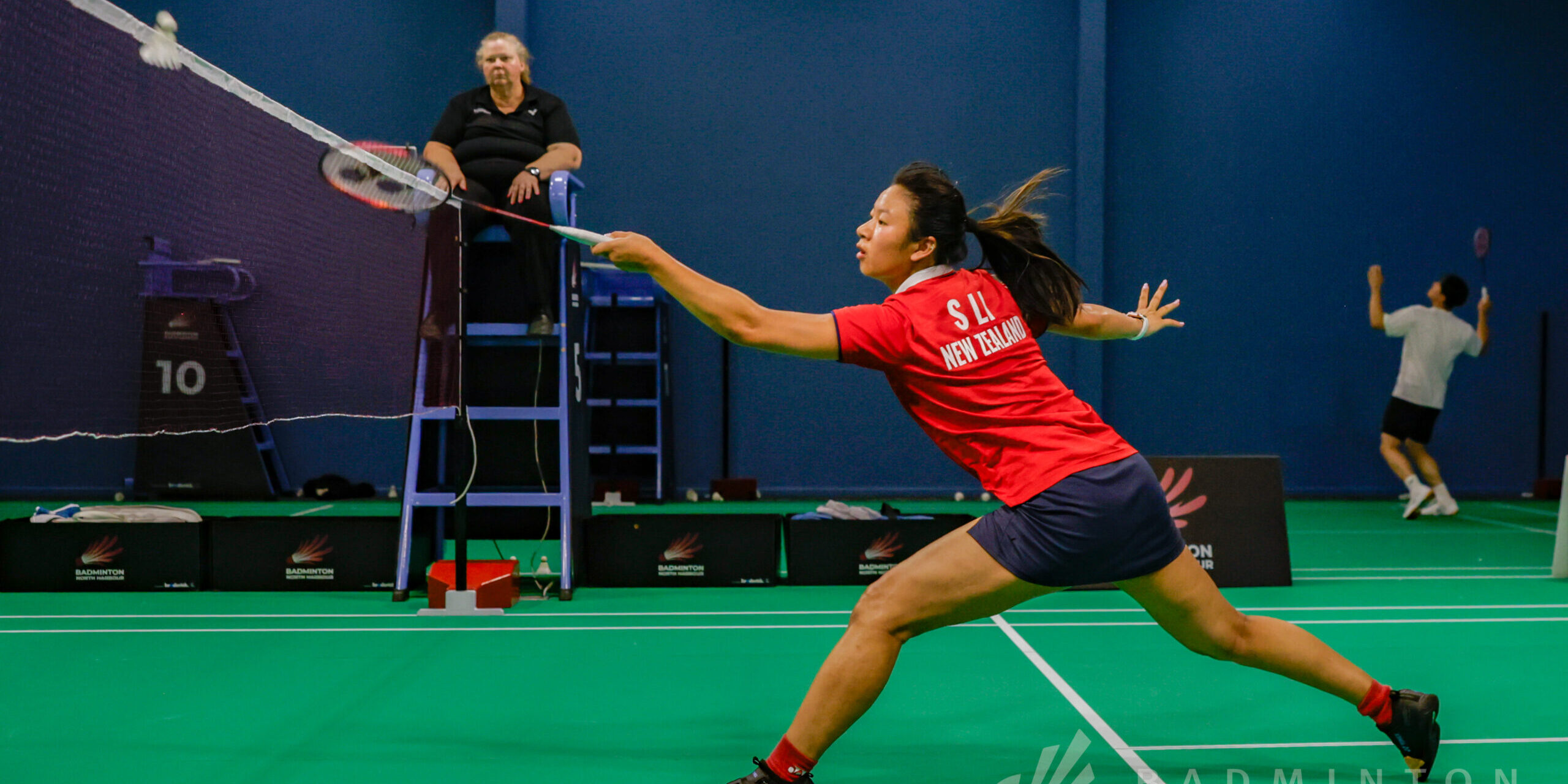 Number three seeded player hits shuttle in badminton match