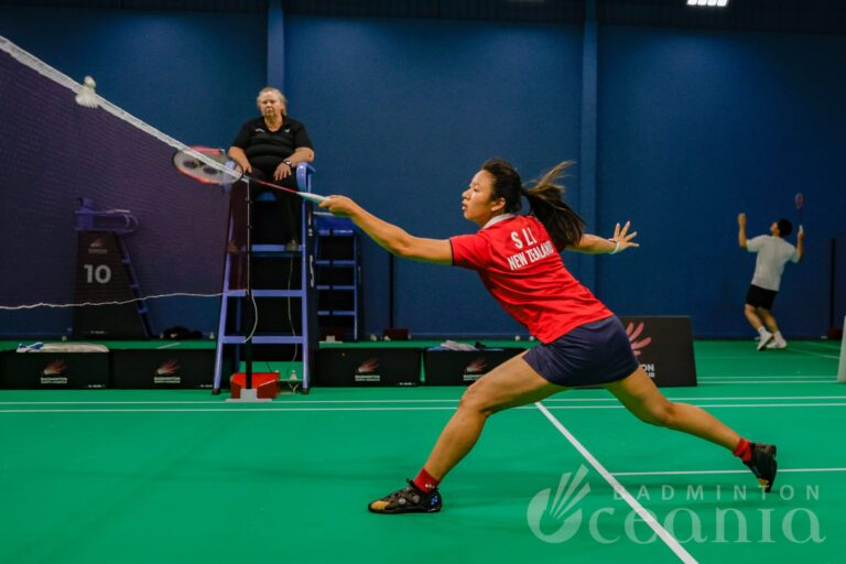 Number three seeded player hits shuttle in badminton match