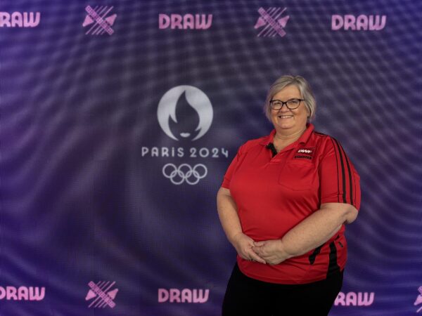 Lynne poses with Paris 2024 Olympics sign