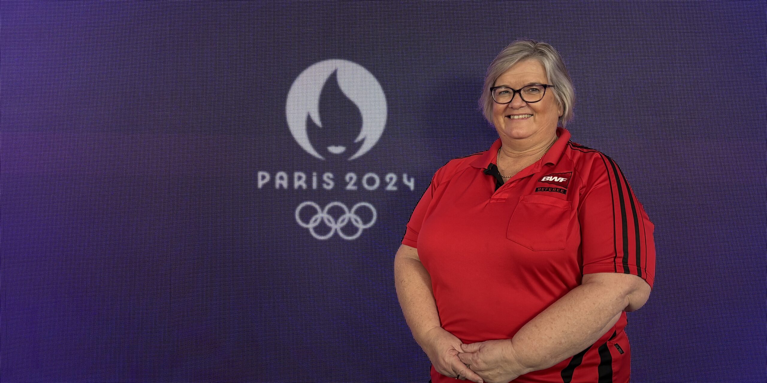 2024-07-12 22.03.43 1 Lynne poses with Paris 2024 Olympics sign