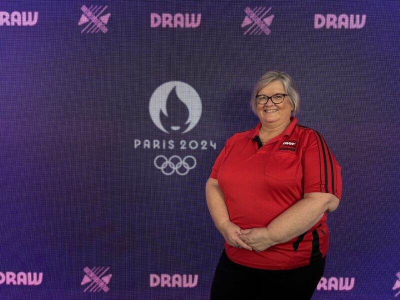 Lynne poses with Paris 2024 Olympics sign