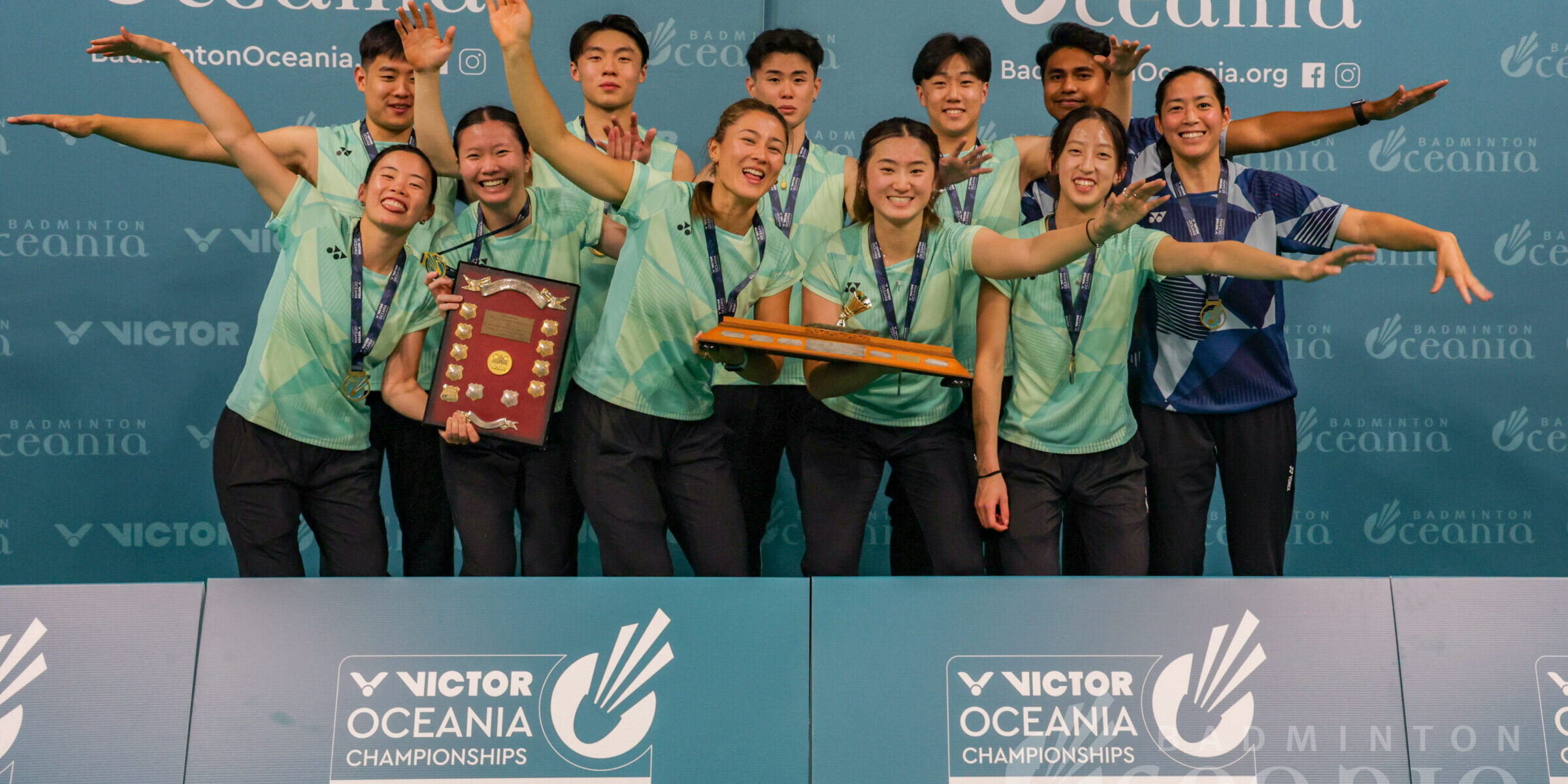 Australia holds the VICTOR Oceania Mixed Team trophy at prizegiving