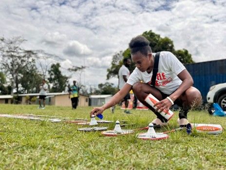 Raylyne sets up shuttles on grass for Shuttle Time session at local school