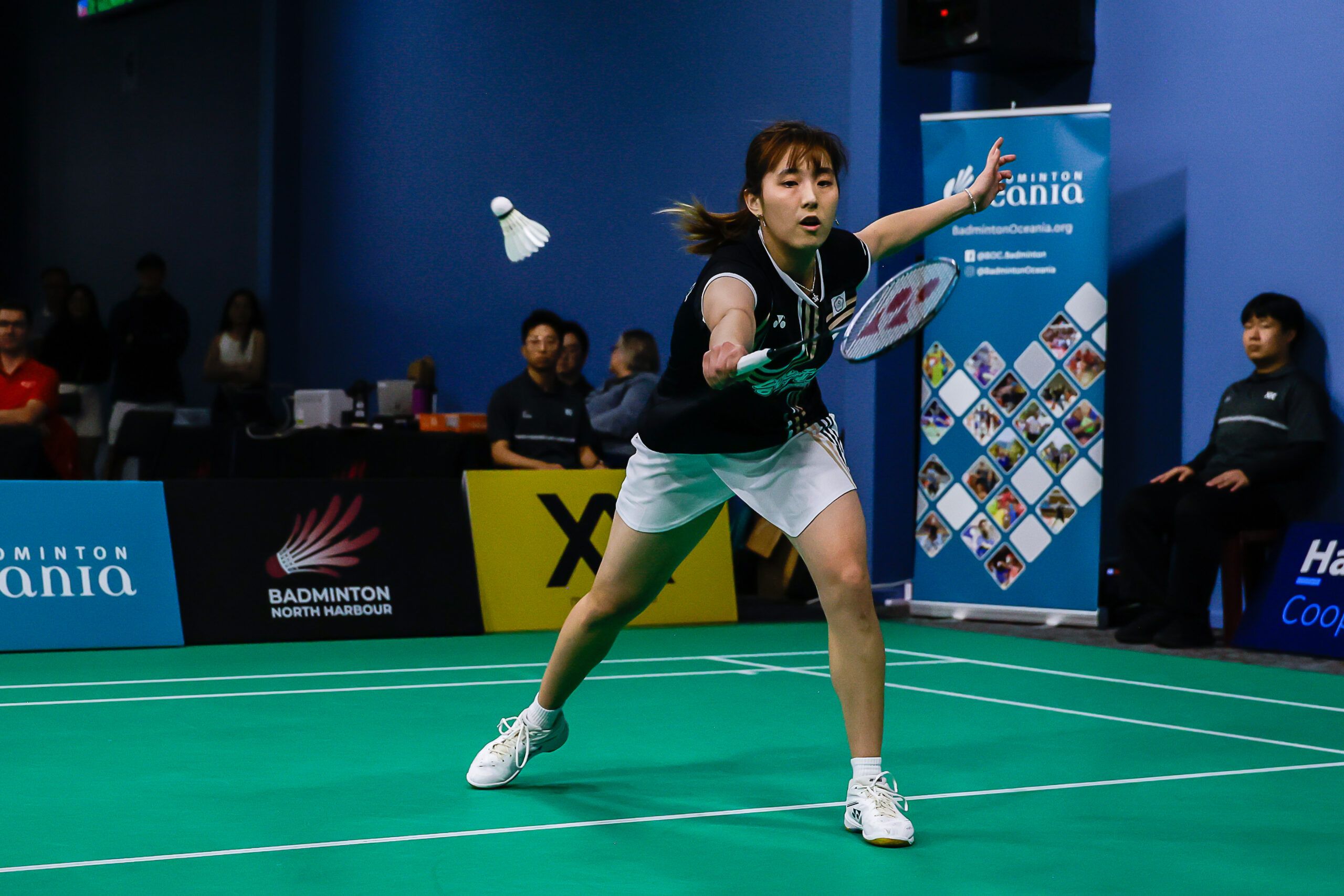Player hits shuttle in badminton final